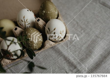 Easter holiday. Painted olive-colored eggs on a linen tablecloth. Easter decoration. Easter holiday. Painted olive-colored eggs on a linen tablecloth. Easter decoration. 135767664
