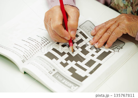 Bangkok, Thailand - May 15, 2022 elderly woman playing sudoku puzzle game. Bangkok, Thailand - May 15, 2022 elderly woman playing sudoku puzzle game. 135767811