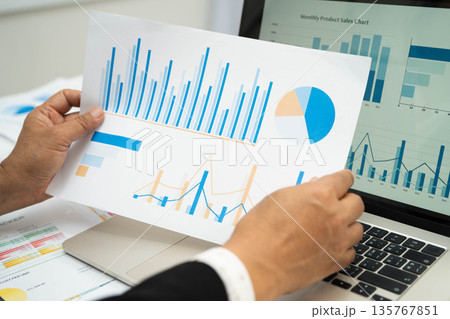 Asian business woman working with financial graph. 135767851