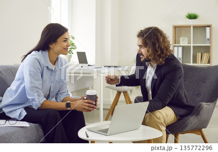 Company worker and female client are meeting in office to negotiate business deal Company worker and female client are meeting in office to negotiate business deal 135772296