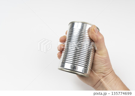 a can of food in the hand 135774699
