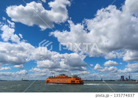 Staten Island Ferry on the bay on a sunny day with clouds and blue sky in New York, NY, USA. August 27, 2025 135774837