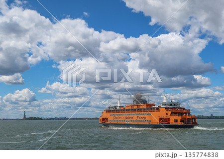 Staten Island Ferry on the bay on a sunny day with clouds and blue sky in New York, NY, USA. August 27, 2025 135774838