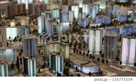 A detailed layout of a city complex is displayed with various building designs, streets, and green spaces, highlighting urban planning for real estate and insurance purposes. A detailed layout of a city complex is displayed with various building designs, streets, and green spaces, highlighting urban planning for real estate and insurance purposes. 135775554