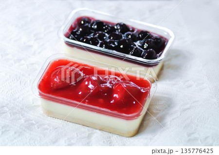 strawberry cheese cake , strawberry cheese pie or strawberry cheesecake and blueberry cheesecake in the box 135776425