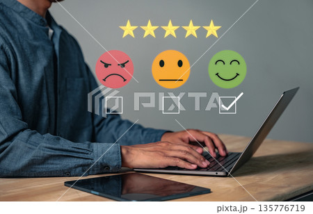 Customer feedback and satisfaction survey shows a man using his laptop to give a rating with a smile icon highlighting the importance of the customer experience and business reviews Customer feedback and satisfaction survey shows a man using his laptop to give a rating with a smile icon highlighting the importance of the customer experience and business reviews 135776719