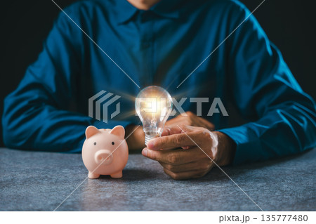 Knowledge and financial innovation, hand holds glowing lightbulb for business research, light bulb idea concept for saving money and successful investment planning wealth growth Knowledge and financial innovation, hand holds glowing lightbulb for business research, light bulb idea concept for saving money and successful investment planning wealth growth 135777480