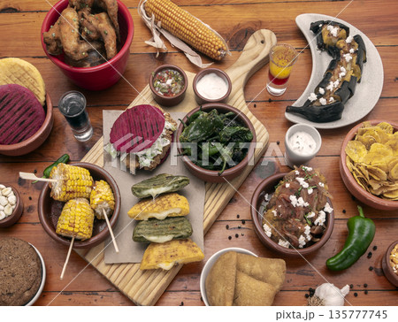 mixed colombian and venezuelan food meal spread on wooden restaurant table mixed colombian and venezuelan food meal spread on wooden restaurant table 135777745