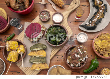 mixed colombian and venezuelan food meal spread on wooden restaurant table mixed colombian and venezuelan food meal spread on wooden restaurant table 135777748