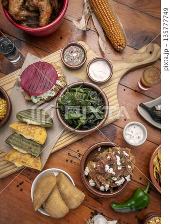 mixed colombian and venezuelan food meal spread on wooden restaurant table mixed colombian and venezuelan food meal spread on wooden restaurant table 135777749