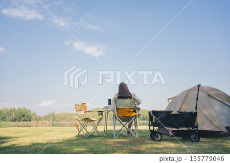 asian couple fun happy and relax with camping and picnic at side of lake with mountain background asian couple fun happy and relax with camping and picnic at side of lake with mountain background 135779046