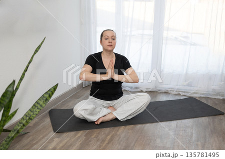 Yoga Session in a Bright Room With Natural Light in the Afternoon Yoga Session in a Bright Room With Natural Light in the Afternoon 135781495
