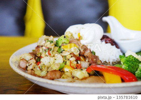 Close up stir-fried pork with cauliflower with boiled egg, fish sauce, broccoli and raspberry rice on a white plate Close up stir-fried pork with cauliflower with boiled egg, fish sauce, broccoli and raspberry rice on a white plate 135781610