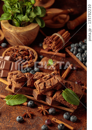 Brownie with blueberries and mint. 135782210