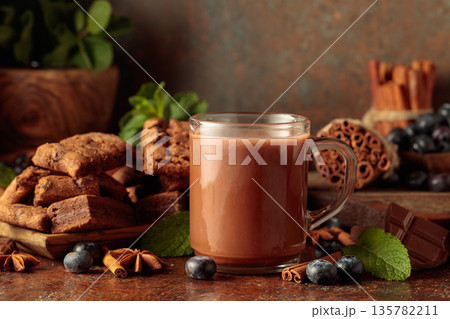 Brownie, mug of chocolate drink, fresh blueberries and mint. 135782211