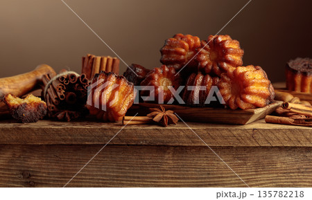 Cinnamon cakes with ingredients on an old wooden table. 135782218