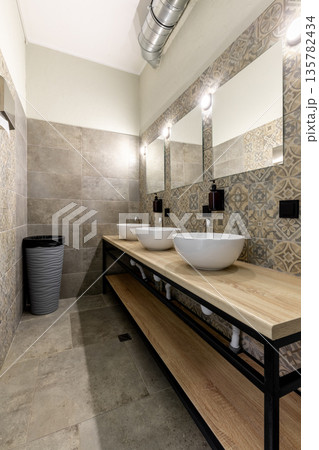 Modern hostel bathroom interior with three white vessel sinks Modern hostel bathroom interior with three white vessel sinks 135782434