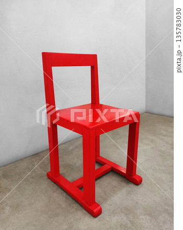 Side view of the red chair on the cement floor. Side view of the red chair on the cement floor. 135783030