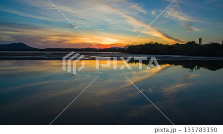 Golden Hour Glow Across a Tranquil Lake Golden Hour Glow Across a Tranquil Lake 135783150