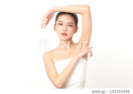 Beautiful Young Asian woman Raises her hands to Showcase clean and hygienic underarms Against a white background, Smooth armpit cleanliness and protection concept Beautiful Young Asian woman Raises her hands to Showcase clean and hygienic underarms Against a white background, Smooth armpit cleanliness and protection concept 135783449