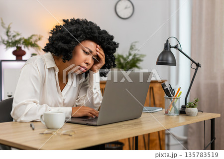 African American businesswoman disappointed sees laptop screen after game loss news client rejection 135783519