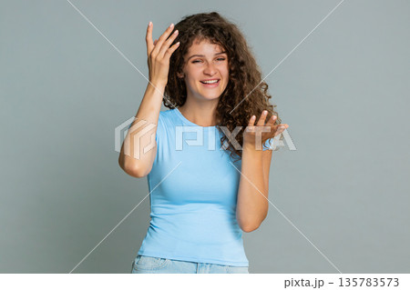 Woman making facepalm gesture laughing humorous reaction embarrassed funny silly mistake moment 135783573
