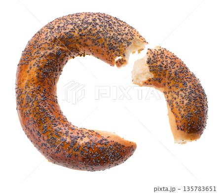Broken into two parts Ruddy bagel sprinkled with poppy seeds on top, on a white background in isolation Broken into two parts Ruddy bagel sprinkled with poppy seeds on top, on a white background in isolation 135783651