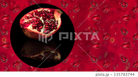 half ripe pomegranate fruit, on a black background in isolation, with reflection, place under the text on the flan of the peel and seeds of the pomegranate 135783744
