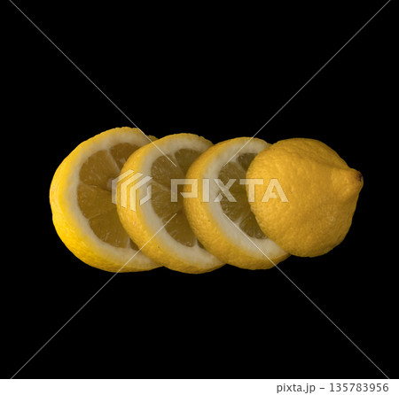 Lemon sliced in round slices on black background isolated 135783956