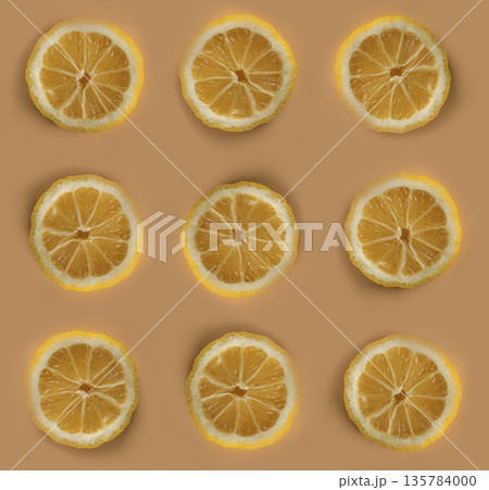 Pieces of lemon, Lemon sliced into slices on a background of apricot color in isolation 135784000