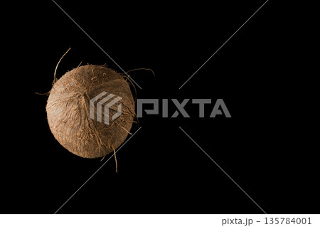 One whole ripe coconut, on black background, isolated One whole ripe coconut, on black background, isolated 135784001