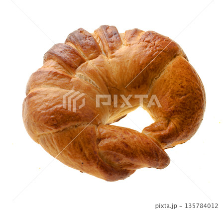 Confectionery product ruddy bun in the shape of a donut, view from the top, on a white background in isolation Confectionery product ruddy bun in the shape of a donut, view from the top, on a white background in isolation 135784012