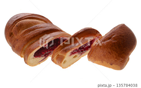 Confectionery product, bun in the form of a roll, two pieces are cut from one edge, on a white background in isolation Confectionery product, bun in the form of a roll, two pieces are cut from one edge, on a white background in isolation 135784038