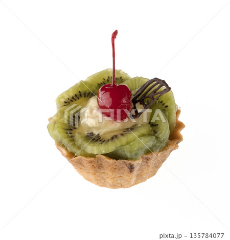 Dessert, cake with kiwi and cherries, on a white plate isolated Dessert, cake with kiwi and cherries, on a white plate isolated 135784077