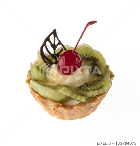 Dessert, cake with kiwi and cherries, on a white plate isolated Dessert, cake with kiwi and cherries, on a white plate isolated 135784078