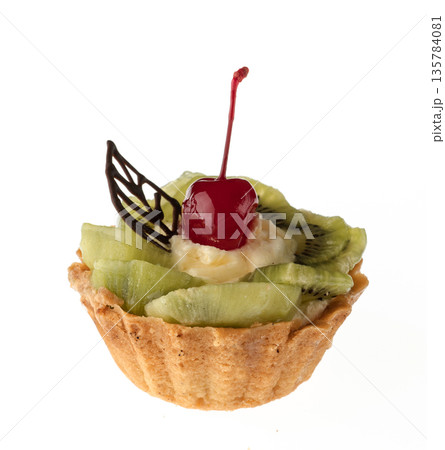 Dessert, cake with kiwi and cherries, on a white plate isolated Dessert, cake with kiwi and cherries, on a white plate isolated 135784081
