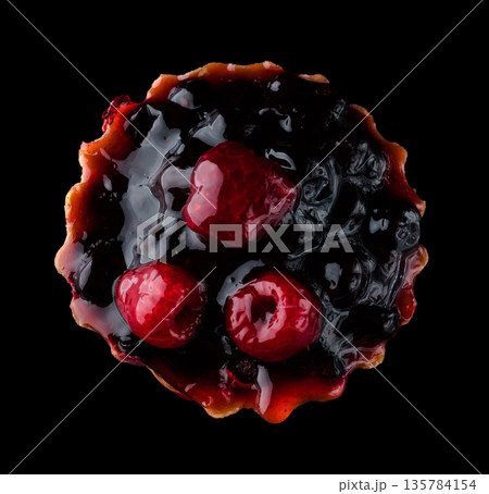 Pastry stuffed with fruits, berries and citrus fruits on a black background in isolation, view from the top, confectionery product 135784154