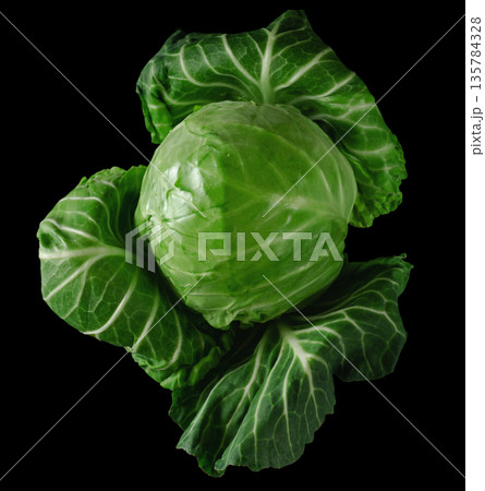 Head of green young fresh cabbage with loose leaves, on black background Head of green young fresh cabbage with loose leaves, on black background 135784328