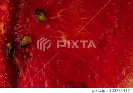Ripe watermelon pulp and watermelon seeds, close up 135784437
