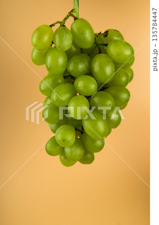 Grapes of white filling, with large sponges on a yellow background Grapes of white filling, with large sponges on a yellow background 135784447