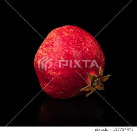 Pomegranate, citrus fruit on a black background with reflection Pomegranate, citrus fruit on a black background with reflection 135784475