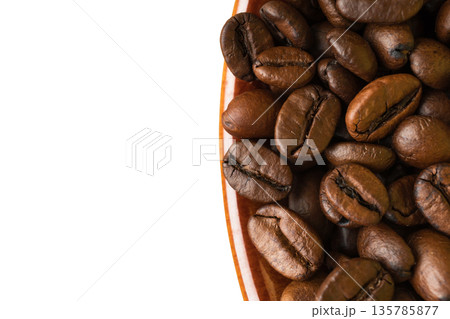 coffee grains in a cup, close-up, on a white background 135785877