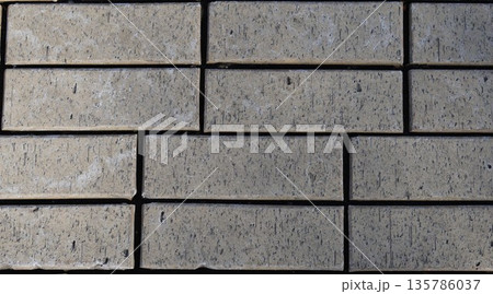 gray paving slabs lined in rows, texture, background 135786037