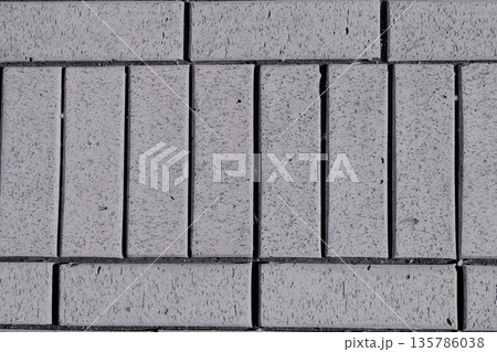 gray paving slabs lined in rows, texture, background 135786038