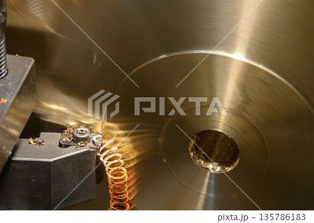 Close Up of Lathe Machine Cutting Brass Parts with Continuous Chip Close Up of Lathe Machine Cutting Brass Parts with Continuous Chip 135786183