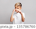 Handsome boy making fists in box stance. Kid in boxing pose. Child practicing self defense or showing playful toughness, isolated on gray studio background 135786760