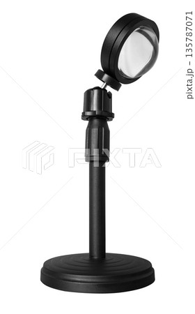 Lamp illuminator on a tripod, on a white background in insulation 135787071