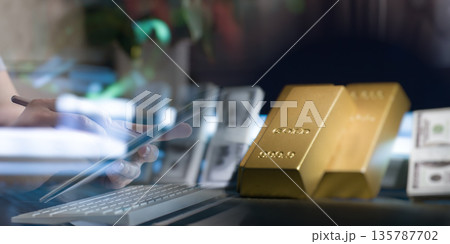 Gold Bullion Bars and US Dollar Cash on Office Desk With Keyboard and Tablet Digital Investment, Commodity Trading, Wealth Management, and Financial Security Concept Gold Bullion Bars and US Dollar Cash on Office Desk With Keyboard and Tablet Digital Investment, Commodity Trading, Wealth Management, and Financial Security Concept 135787702