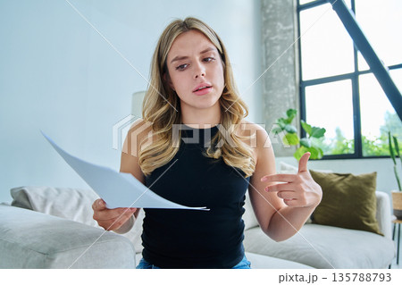 Webcam view young serious woman with business papers having video Webcam view young serious woman with business papers having video 135788793
