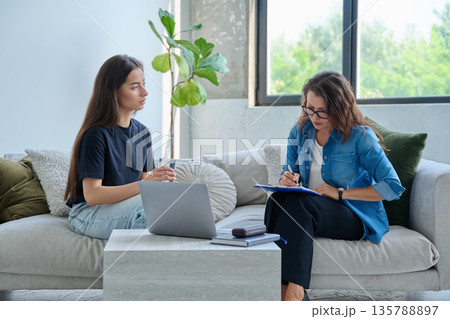 Teenage girl patient in therapy session with social mental therapist 135788897